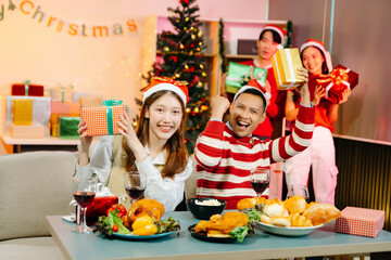 Holiday spirit with Asian friends exchanging gifts, sharing laughs, and enjoying a festive Christmas dinner