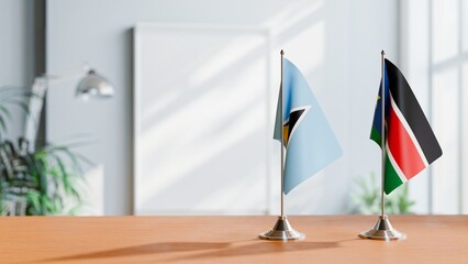 FLAGS OF SAINT LUCIA AND SOUTH SUDAN ON TABLE