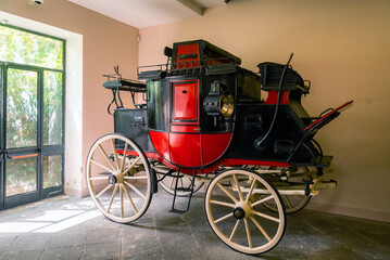 Old coach inside Museum of Villa Pignatelli in Naples, Italy.