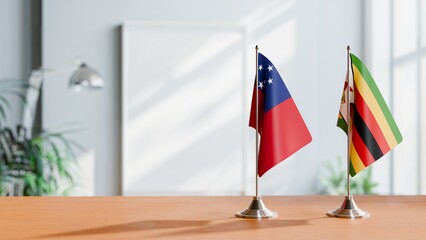 FLAGS OF SAMOA AND ZIMBABWE ON TABLE