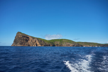 Fototapeta premium Coin de Mire (Gunner's Quoin), a protected Mauritian island 8 km off Mauritius' northern coast, is known for its steep profile and birdlife but is not open to visitors.