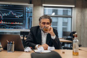 Drinking alcohol, depression. Senior man is in the modern office