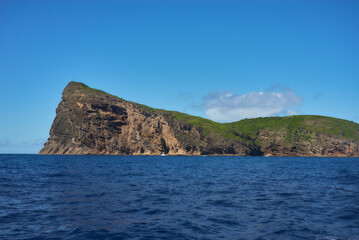Fototapeta premium Coin de Mire (Gunner's Quoin), a protected Mauritian island 8 km off Mauritius' northern coast, is known for its steep profile and birdlife but is not open to visitors.
