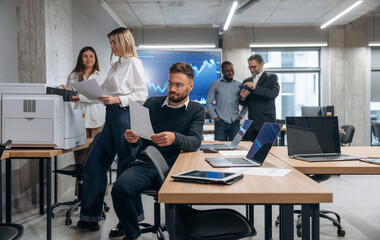 Using printer. Group of office workers are indoors together