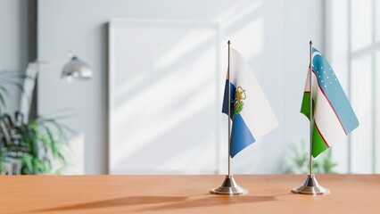 FLAGS OF SAN MARINO AND UZBEKISTAN ON TABLE