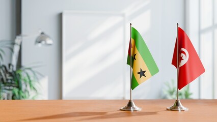 FLAGS OF SAO TOME AND TUNISIA ON TABLE