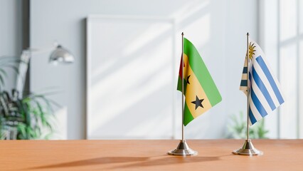 FLAGS OF SAO TOME AND URUGUAY ON TABLE