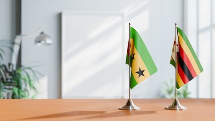 FLAGS OF SAO TOME AND ZIMBABWE ON TABLE