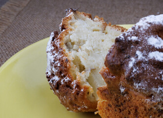 Cut muffin on a yellow plate. Fresh delicious muffin.