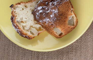 Cut muffin on a yellow plate. Fresh delicious muffin.