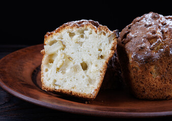 Cut muffin on a clay plate. Fresh delicious muffin.