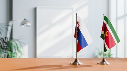 FLAGS OF SLOVAKIA AND SURINAME ON TABLE