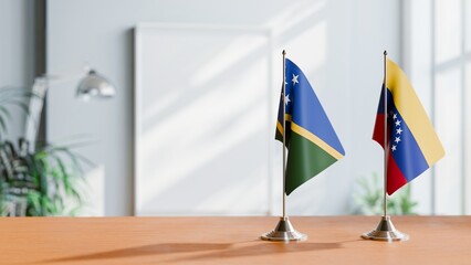 FLAGS OF SOLOMON ISLANDS AND VENEZUELA ON TABLE