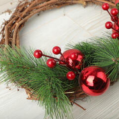 Christmas wreath over wooden background, closeup view. Xmas decoration.