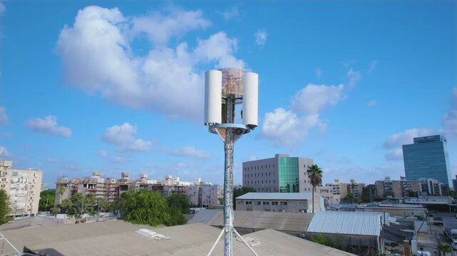 Cell phone mini tower base station on a building in a small industrial area for mobile devices - antenna emitting non-ionizing radiation