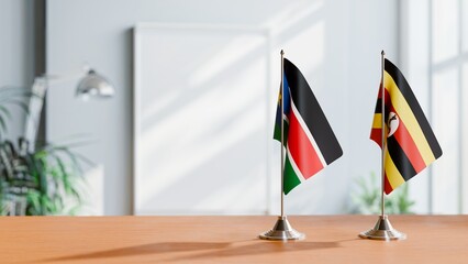 FLAGS OF SOUTH SUDAN AND UGANDA ON TABLE