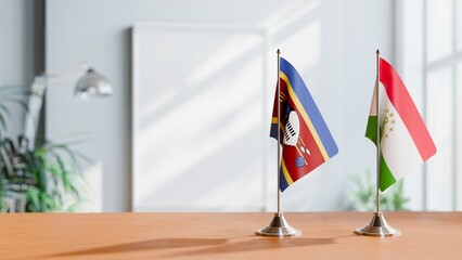 FLAGS OF SWAZILAND AND TAJIKISTAN ON TABLE
