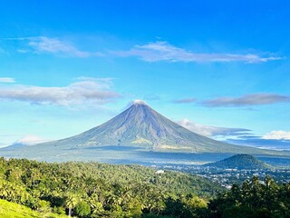 Fototapeta premium Beautiful and fresh air Mayon Volcano View with a green forest and blue sky color nature in legazpi city albay Philippines