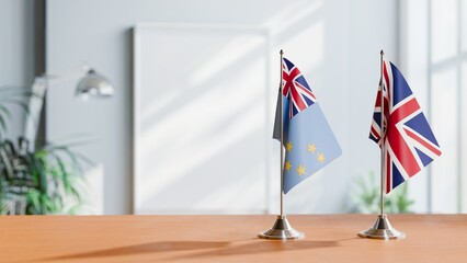 FLAGS OF TUVALU AND UNITED KINGDOM ON TABLE
