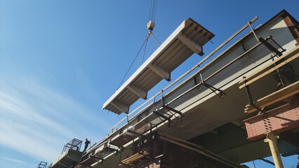 massive industrial crane lifting steel beams at a construction site