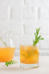Drink, tea, lemonade, cocktail with pear, lemon, rosemary, thyme and ice. Healthy drink, sugar and alcohol free. Vertical orientation.