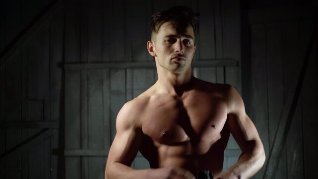 Sexy man undressed shirt. Young sexy man with muscular body takes off his shirt. Sexy male model. Seductive guy. Handsome shirtless man. Muscular male fit body. Male fashion model.