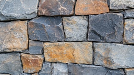 Fototapeta premium A textured stone wall with varied colors and shapes