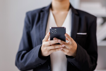 Business Documents, Asian woman standing and holding cellphone for analysis TAX, accountant Documents data contract partner deal in workplace office.