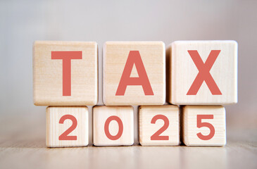 Numbers 2025 and text Tax on cubes on a blue background
