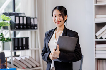 Photo of cheerful corporate agent woman smile hold use wireless laptop netbook networking at workplace office background
