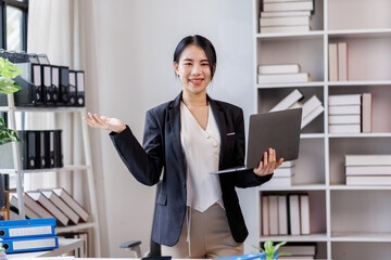 Photo of cheerful corporate agent woman smile hold use wireless laptop netbook networking at workplace office background
