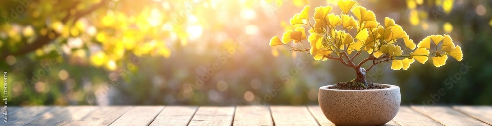 Aufkleber Yellow bonsai tree on wooden surface with blurred bokeh background.