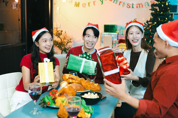 drinks and conversation, people celebrating together at Merry Christmas and Happy New Year. Friends are happy and celebrating with food, wine and friendship of love and gift exchange at the event.