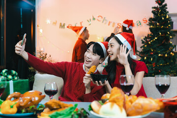 drinks and conversation, people celebrating together at Merry Christmas and Happy New Year. Friends are happy and celebrating with food, wine and friendship of love and gift exchange at the event.