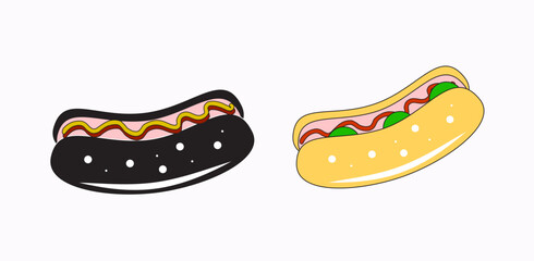 Two hot dogs, one with a black bun topped with mustard and ketchup, and the other with a yellow bun topped with lettuce, tomato, and mayonnaise.