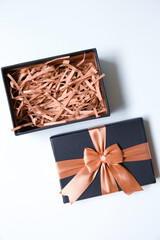 Open gift box with shredded paper