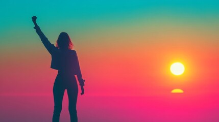 Fototapeta premium Woman Silhouetted Against Vibrant Sunset Triumphantly Raising Arm