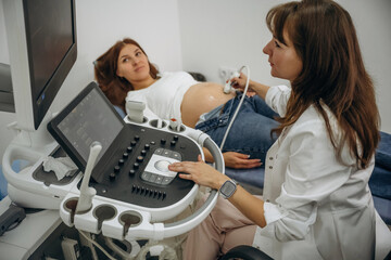 Conception of anticipation. Pregnant woman undergoing ultrasound test