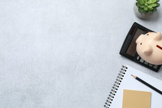 Top above overhead view photo of office accessories calculator, notebook and pencil on gray backdrop with blank empty space
