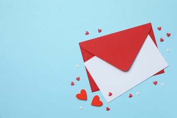 Paper card with red envelope and hearts on color background