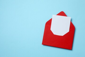 Paper card with red envelope on color background