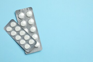 Blisters with tablets on a colored background