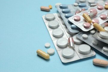 Various blisters with tablets on a colored background