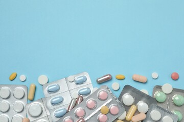 Various blisters with tablets on a colored background