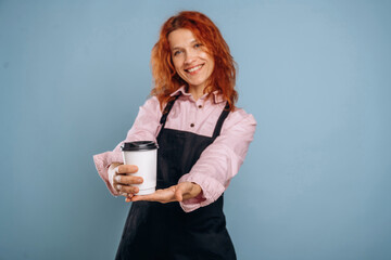 Fresh drink in white paper cup. Woman is in the studio against background