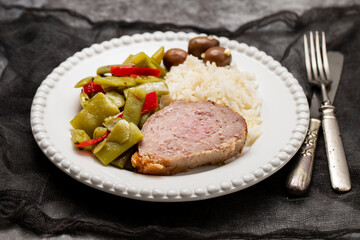 Meat rolls stuffed with ham with boiled rice and olives