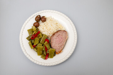 Meat rolls stuffed with ham with boiled rice and olives