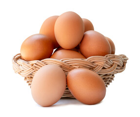 Group of fresh brown chicken eggs in stack in wicker basket isolated on white background with clipping path