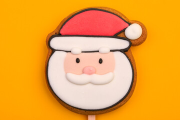 Santa Claus gingerbread cookie on yellow background