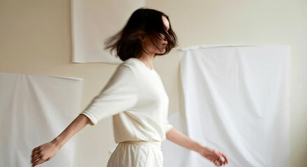 Naklejka premium A woman elegantly sways, her silhouette blurred against minimalist white backdrops